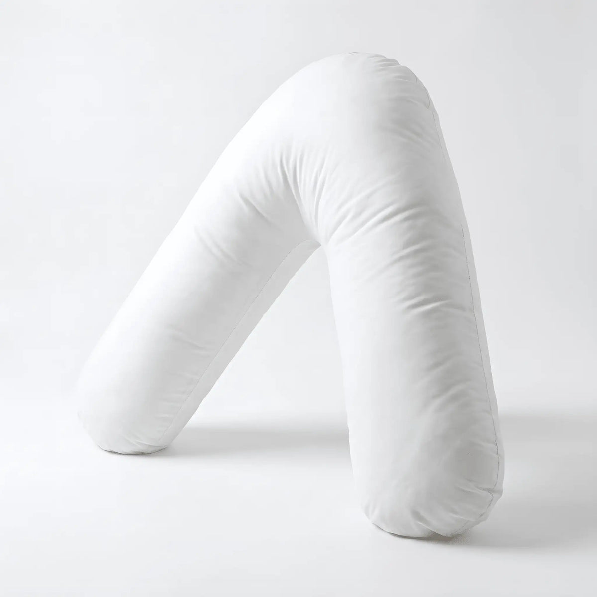 White Nurtura V-shaped support pillow displayed upright against a white background