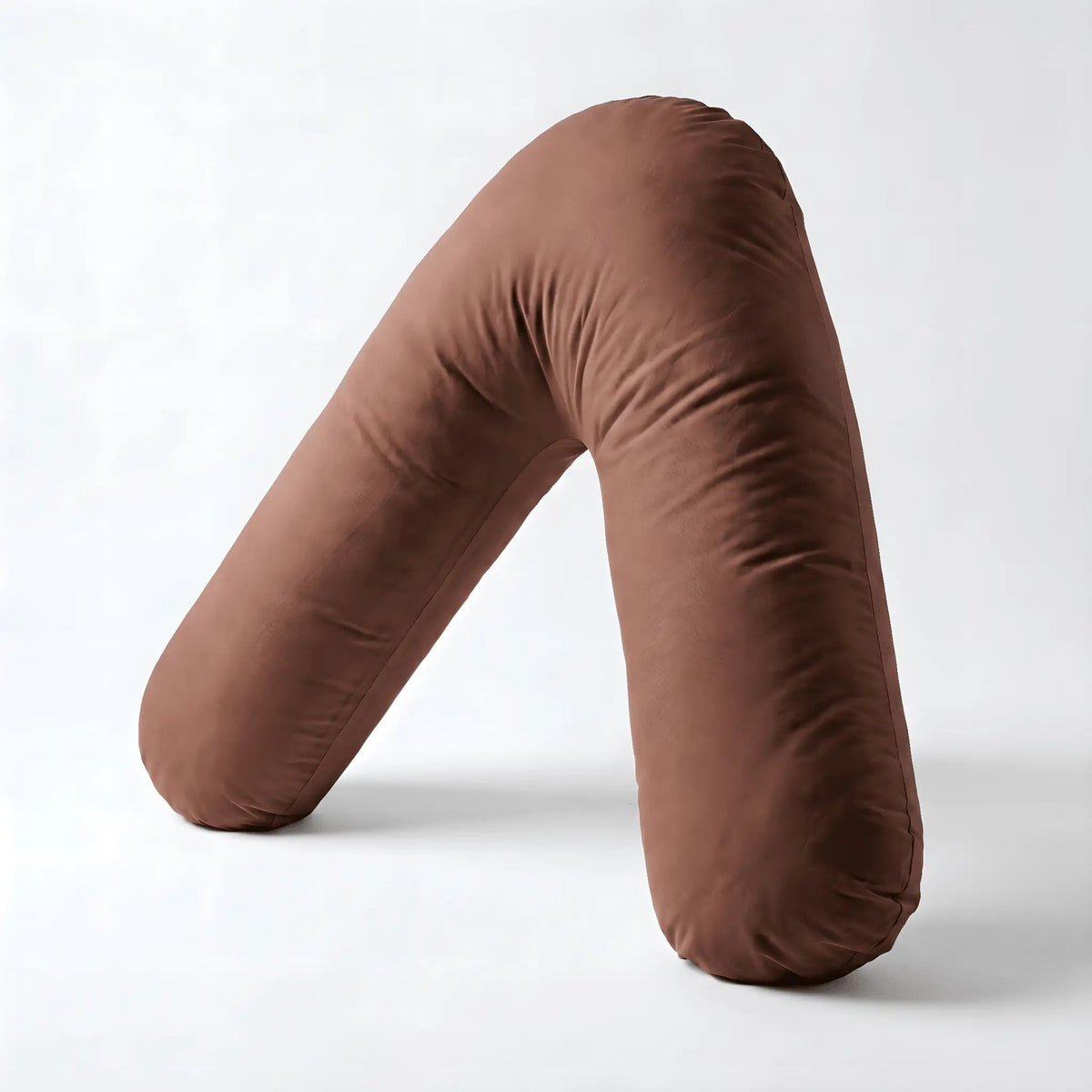 Coffee brown Nurtura V-shaped support pillow showing its cushioned design
